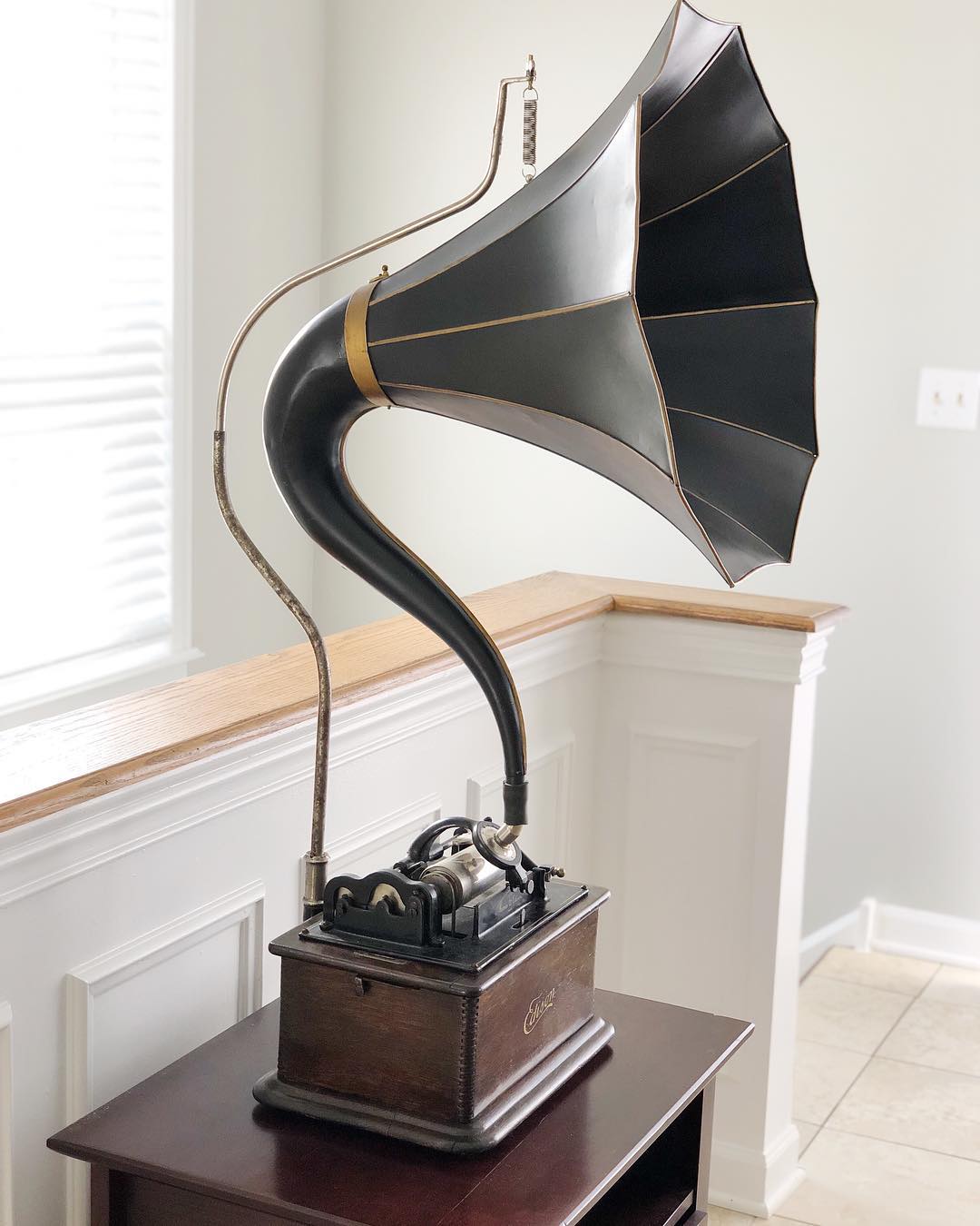 Edison cylinder phonograph with black and gold horn seen from an angle, horn crane visible