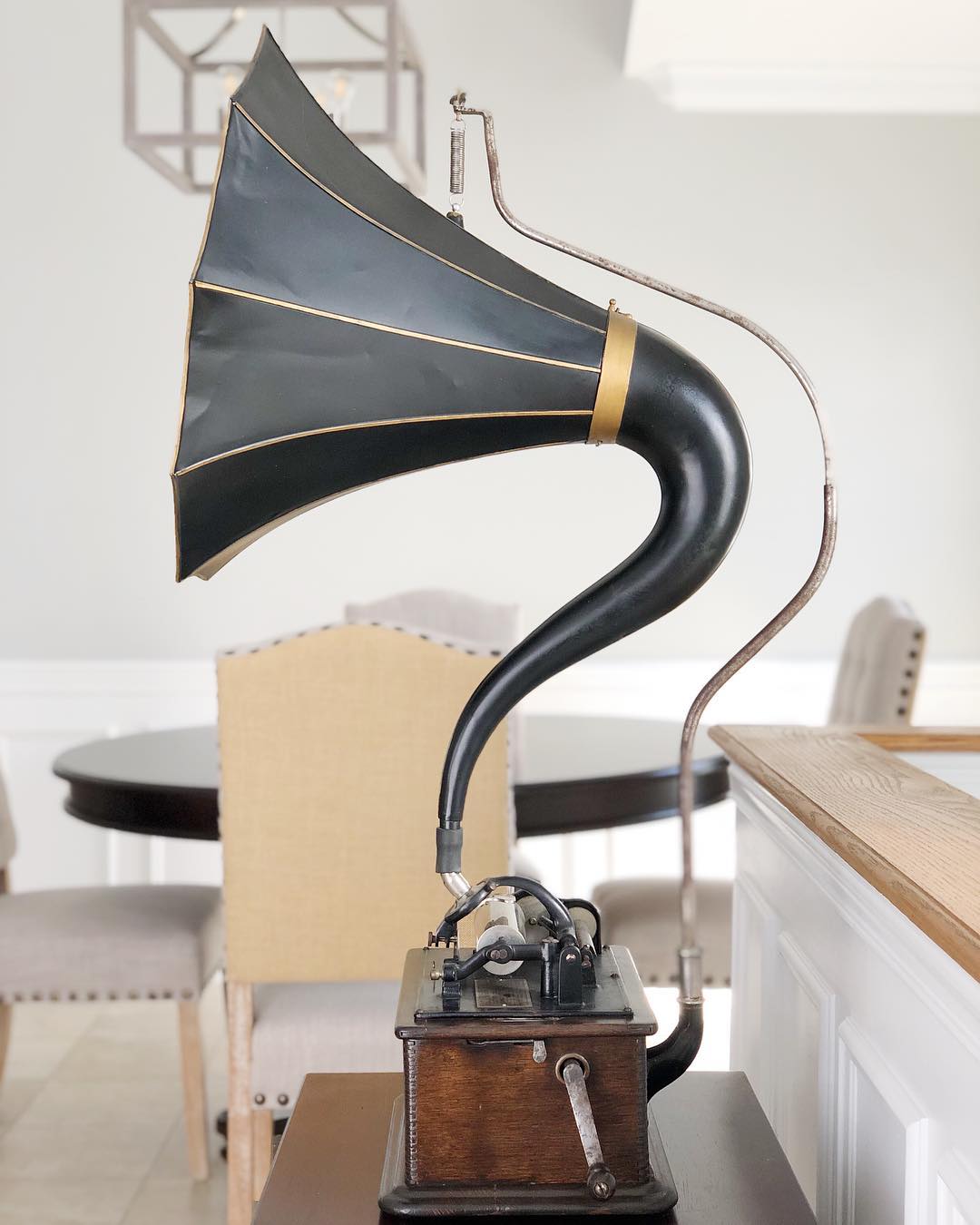 Edison cylinder phonograph with a black and gold morning glory horn on a crane support