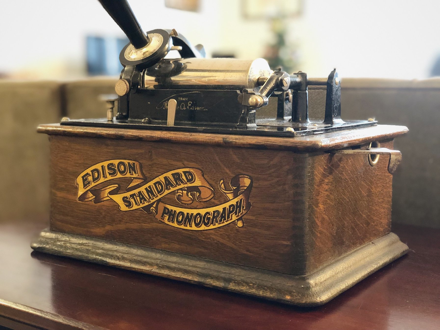 Close view of an Edison Standard Phonograph banner decal and cylinder mandrel