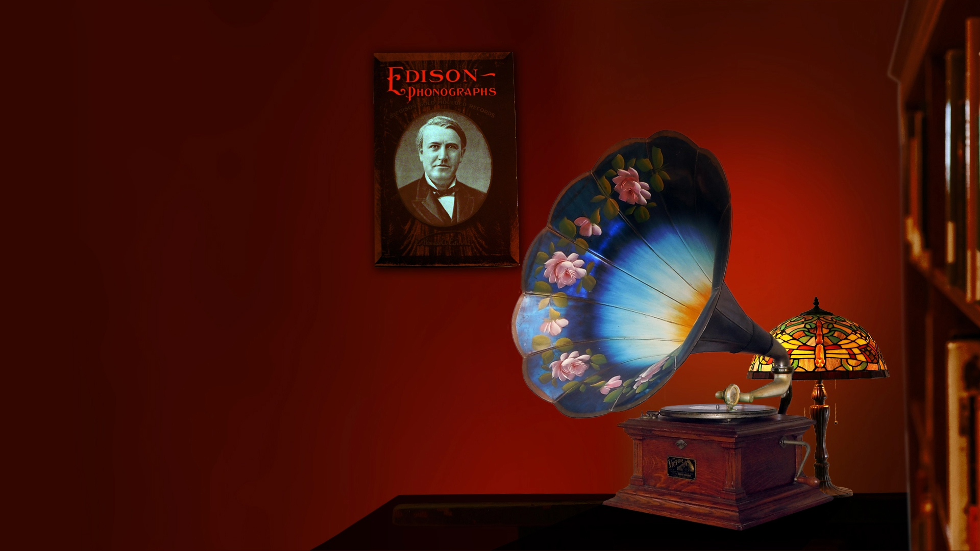 Victor talking machine with a hand-painted morning glory horn beside an antique Edison Phonographs poster